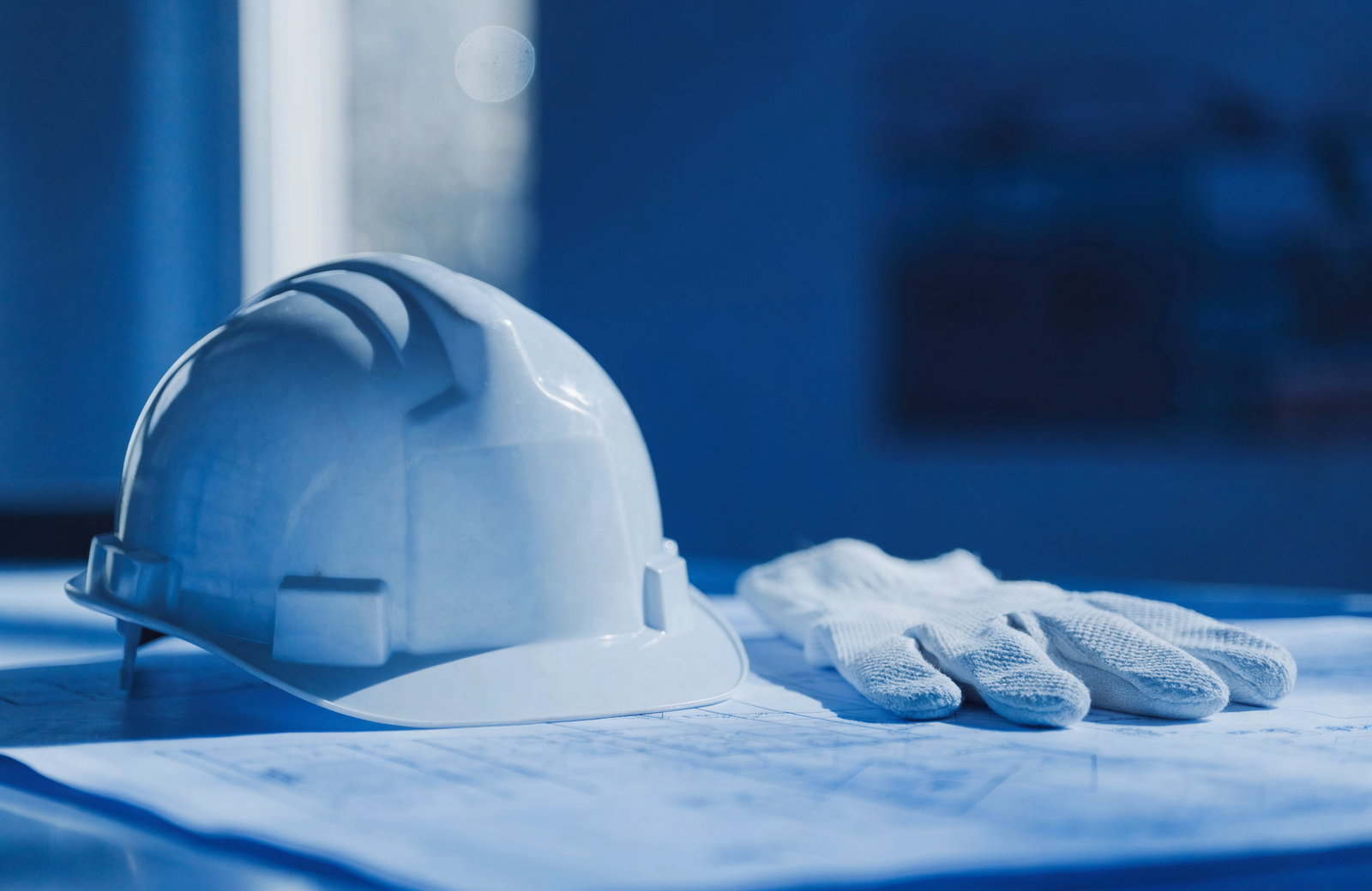 Hard hat and blueprints for hard-to-place workers compensation