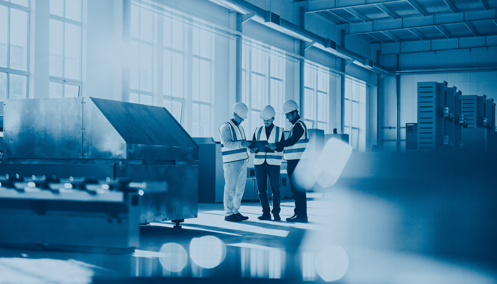 Industrial workers reviewing safety documents