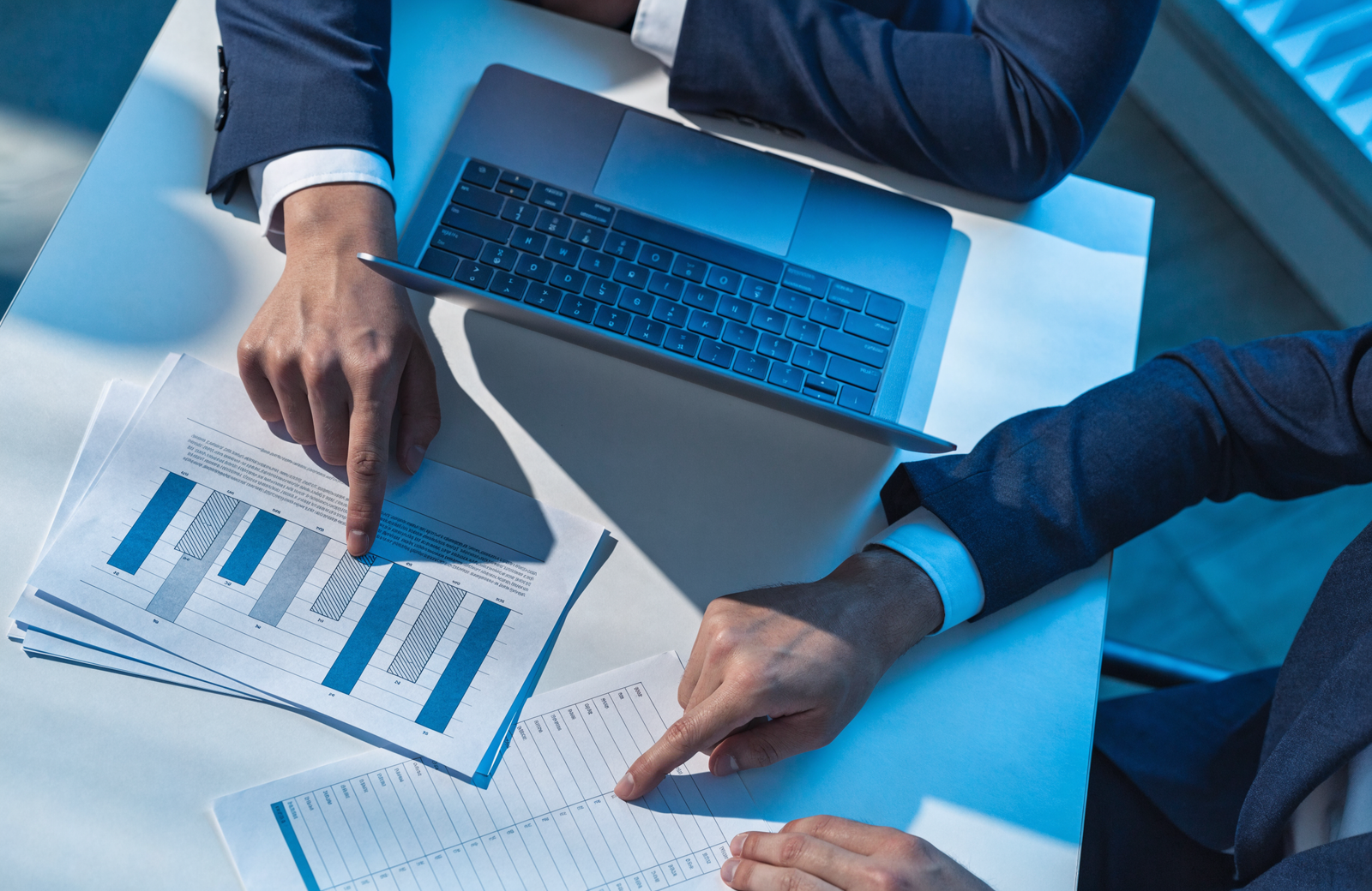 Consultant reviewing rate comparison documents representing PEO education and consulting